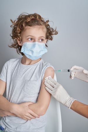 Boy getting vaccine from coronavirus in hospital
