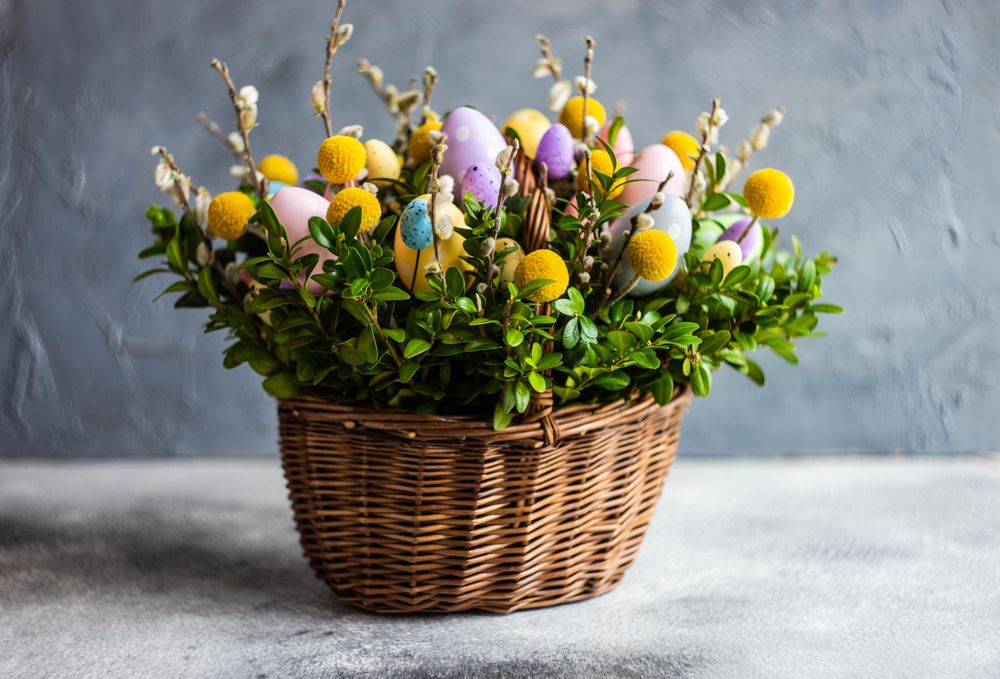 Pastel Easter eggs & flowers in decorative basket
