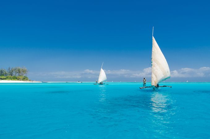 People sailing on a clear day, on clear water
