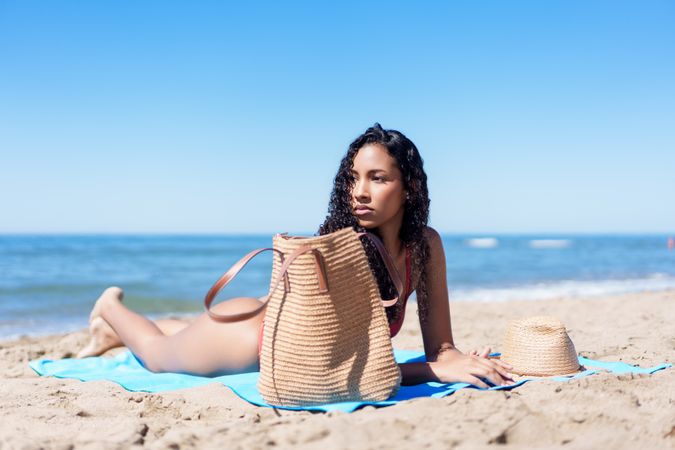 Relaxing Beach Day A Woman Enjoying the Warm Sunlight by the Beautiful Shoreline