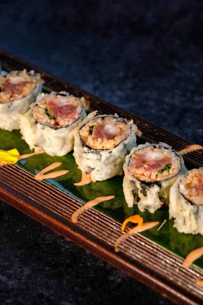 Delicious fried sushi with cream on tray