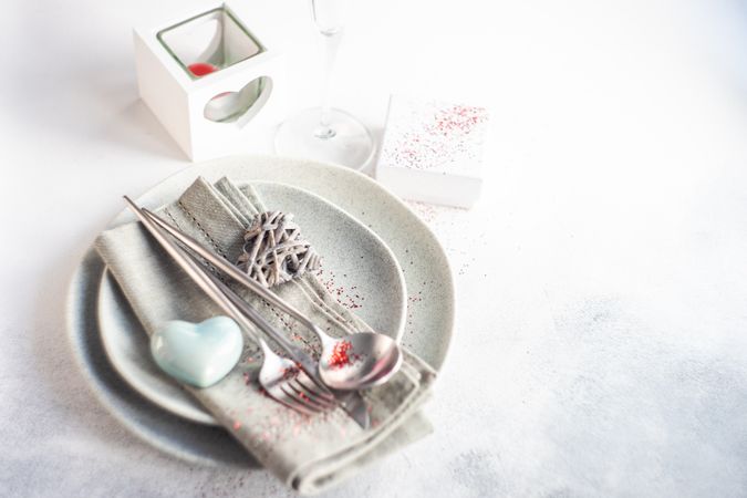 Grey table setting for Valentine's day with blue heart