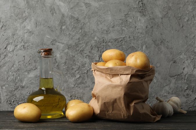 Kitchen counter with olive oil and bag of potatoes