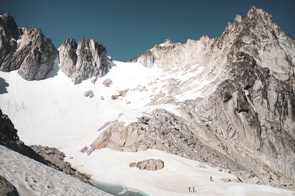 people hiking in mountain covered by snow