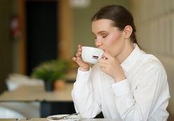 Businesswoman enjoying coffee break in a modern cafeteria