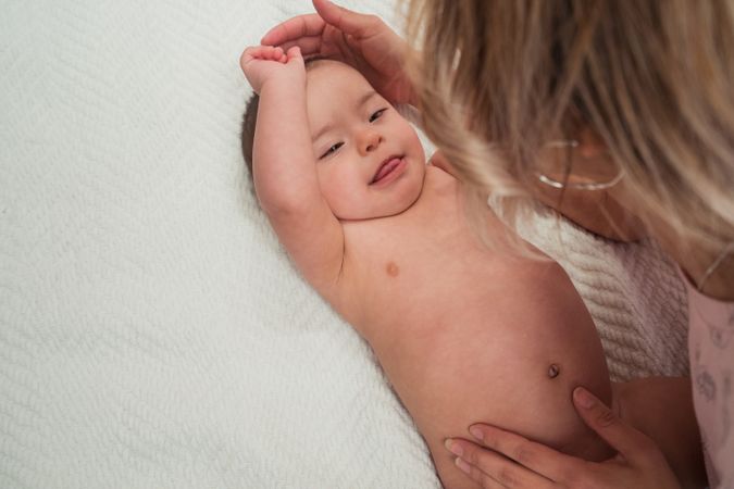Portrait of cute baby boy with Down syndrome and his mother