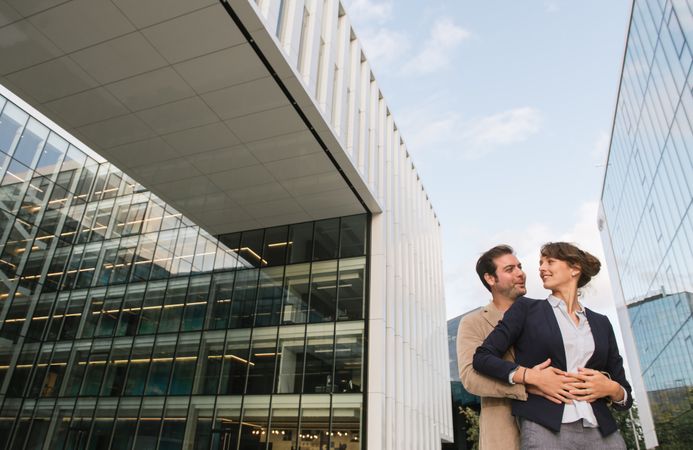 Businesspeople couple outside contemporary building
