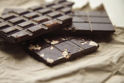 Close up of stack of three chocolate bars on paper