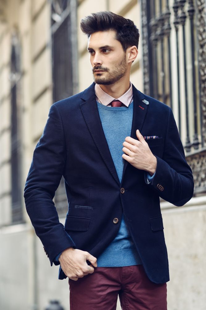 Attractive man in the street wearing elegant suit looking to his side