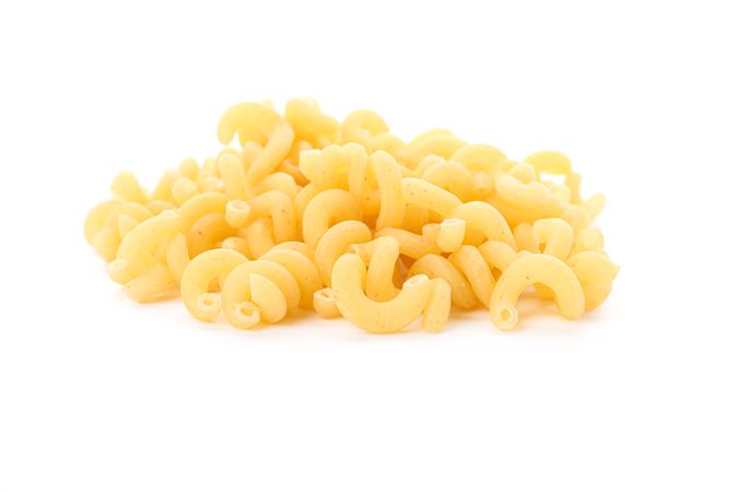 Pasta isolated on light background, closeup. Dry uncooked whole pasta