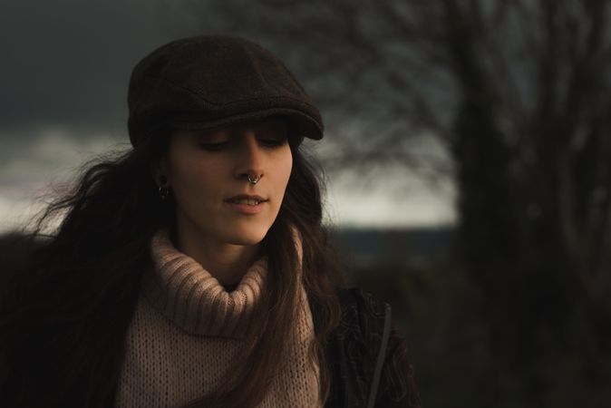 Young woman in warm clothes in forest