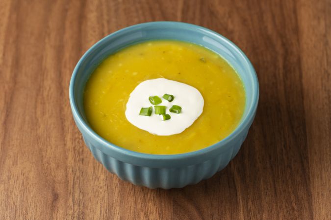 Bowl with pumpkin soup on the table.