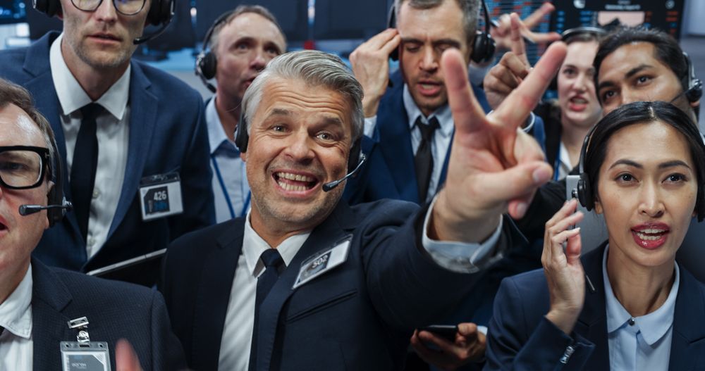 Stock Exchange Professionals Communicating in an Open Outcry Method on a Trading Floor.