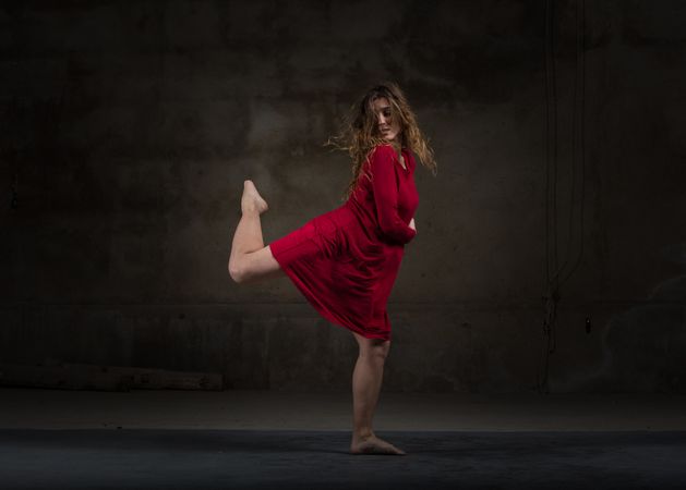 Young woman dancing in darkness