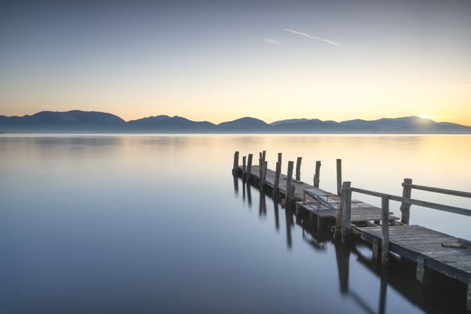 Wooden pier or jetty and lake at sunrise, Torre del lago Puccini Versilia Tuscany, Italy
