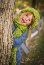 Portrait of Cute Young Girl Wearing Green Scarf and Hat