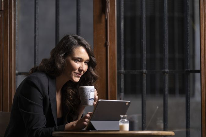 Young female using digital tablet in cafe