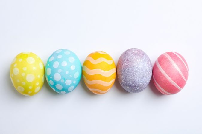 Decorative Easter eggs on neutral background, space for text. Top view