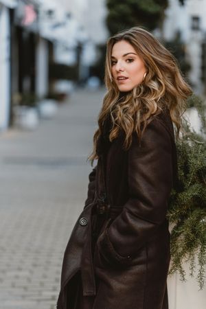 female standing on city street