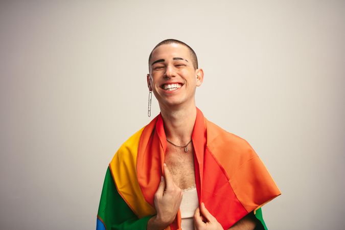 Cheerful man smiling with pride flag