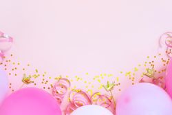 Pink birthday balloons on pink background with copy space