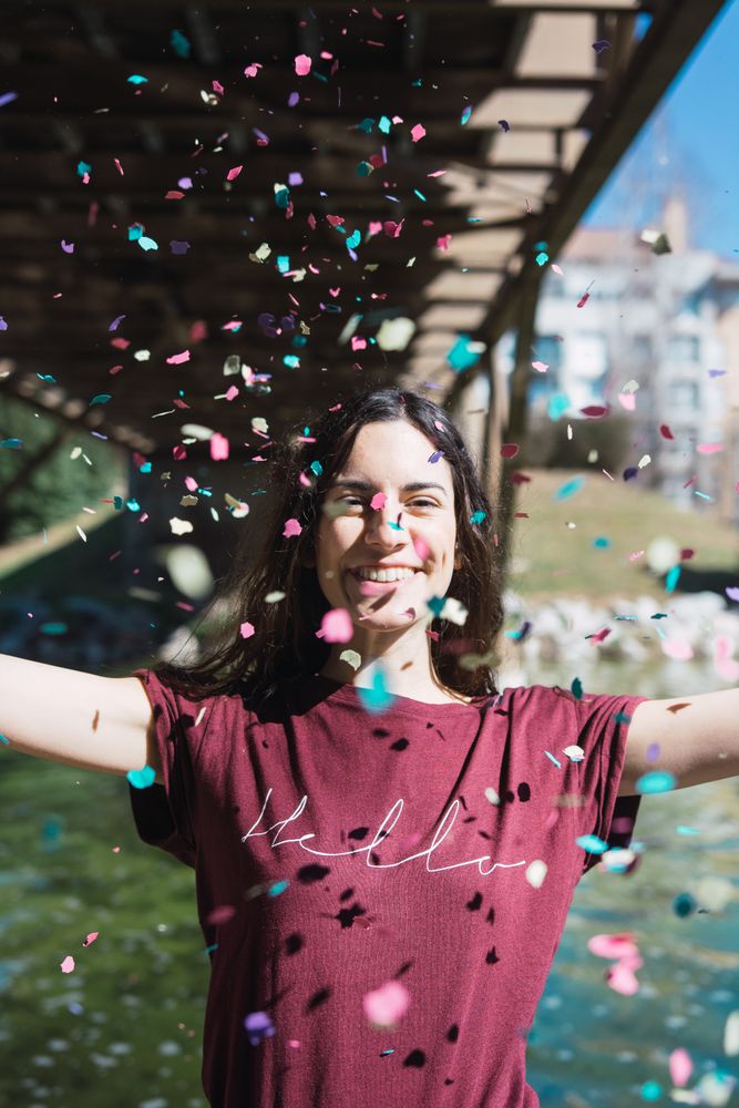 Woman throwing confetti in the air.