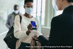 Female in pandemic with digital air ticket at airport 4jvVX4
