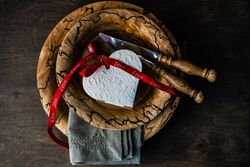 Valentine's day card concept of heart ornament on rustic plate