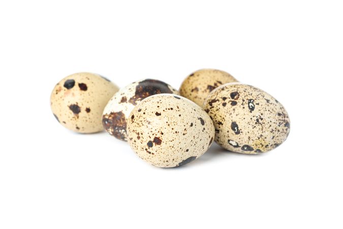Raw quail eggs isolated on plain background