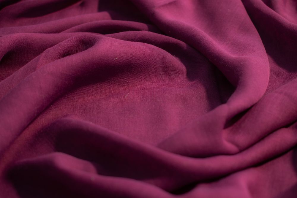Soft purple fabric wavy spiral crumpled background abstract with copy space in the center