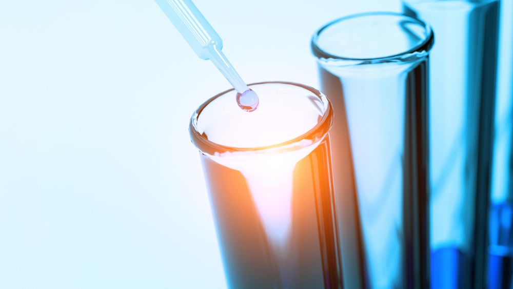 Selective focus on liquid water drop into test tube
