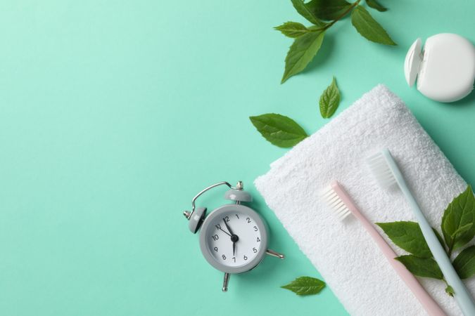 Tools for dental care on mint background, top view