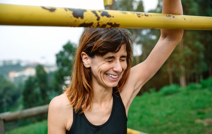 Excited and tired athlete woman after training