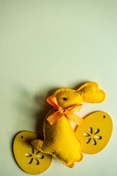 Easter holiday card concept with rabbit and egg ornaments on table