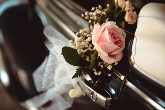 Pink flower on handle of retro car