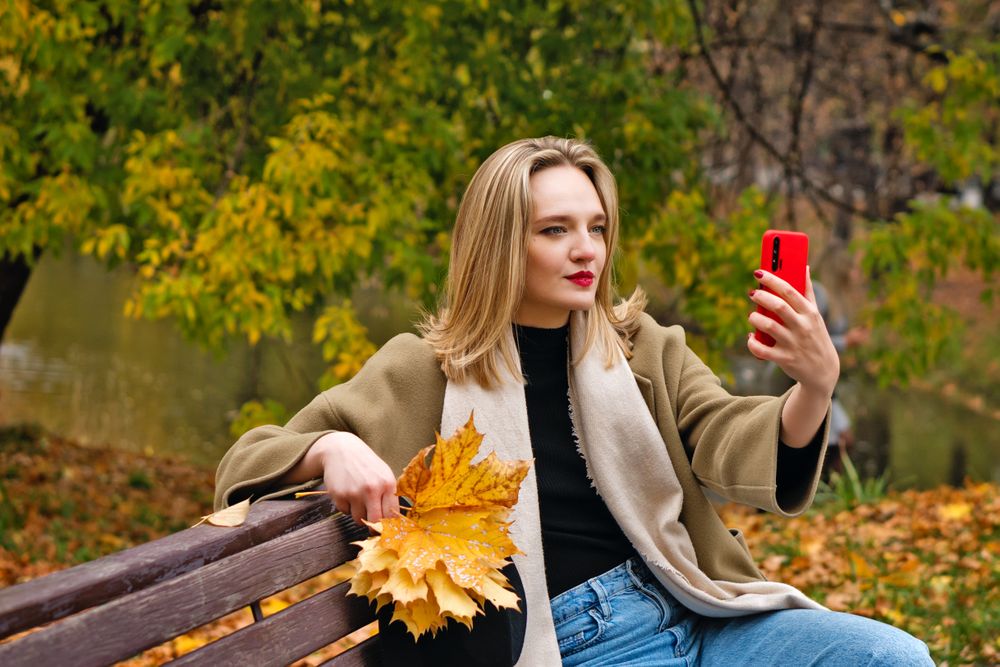 Woman on park bench in autumn