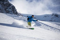 Person snowboarding during daytime