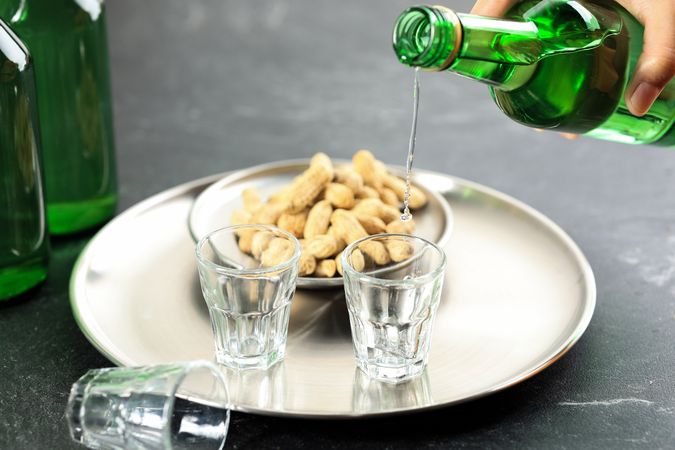 Pouring Soju Water Korean Alcohol to Small Glass