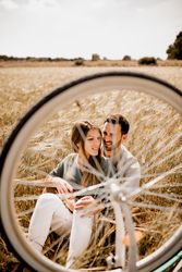 Loving couple resting on rye field