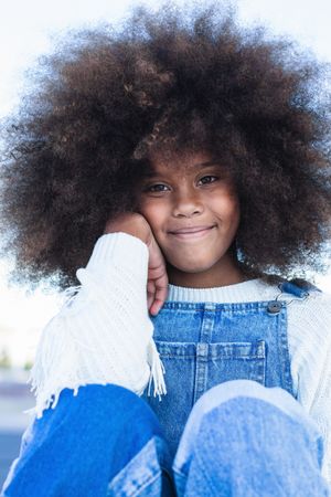 Smiling Black teen girl with curly hair