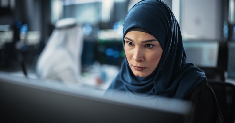Portrait of a Thoughtful Middle Eastern Engineer Working on Computer in a Technological Corporate Office.