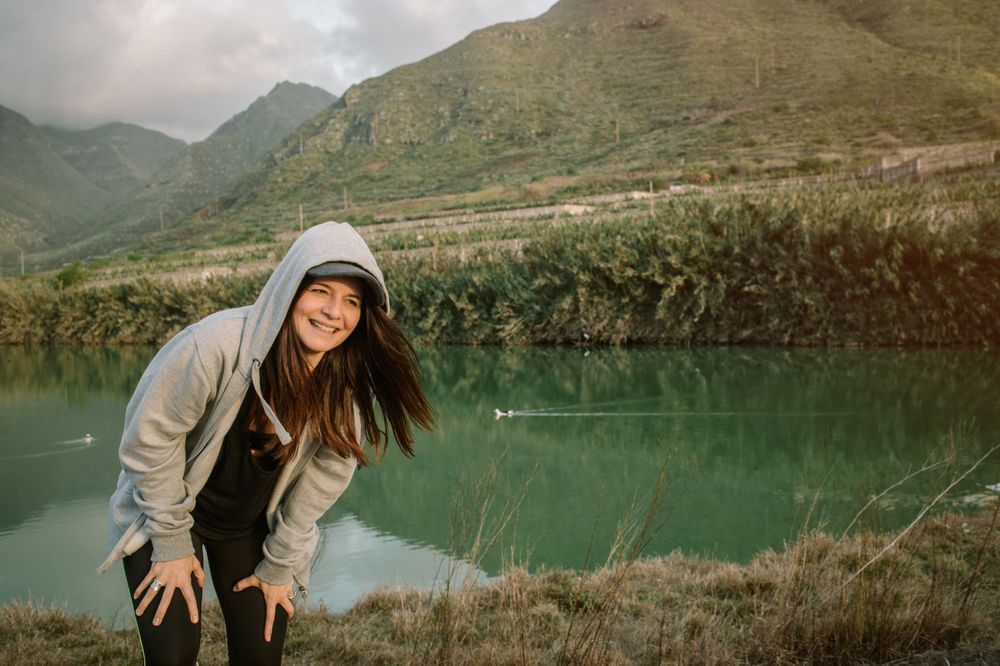 Positive woman running in park