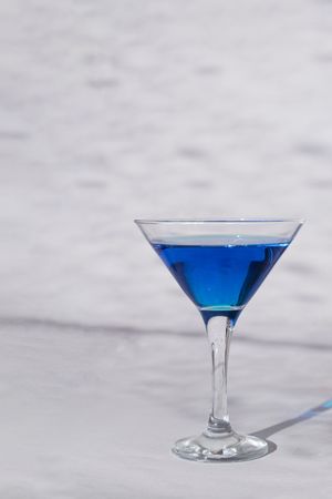 Blue cocktail in martini glass