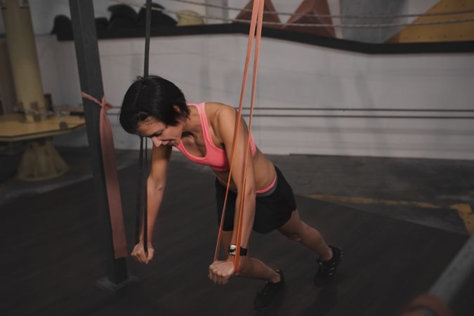 Athletic young woman training in gym