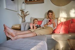 Mother and son resting on couch together