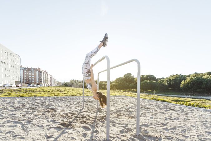 Woman training on parallel bars