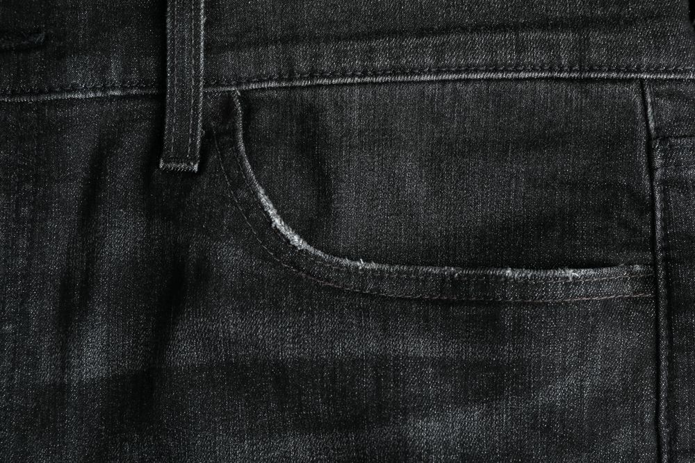 Closeup view of jeans pocket as background, space for text