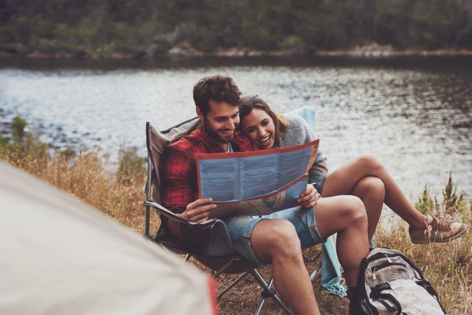 Romantic young couple camping next to the lake