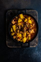 Top view of hearty Georgian meat and vegetable stew Souzi on wooden board