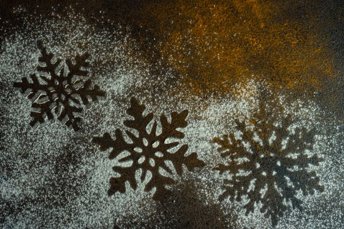 Christmas card concept or snowflake shape in snow on counter